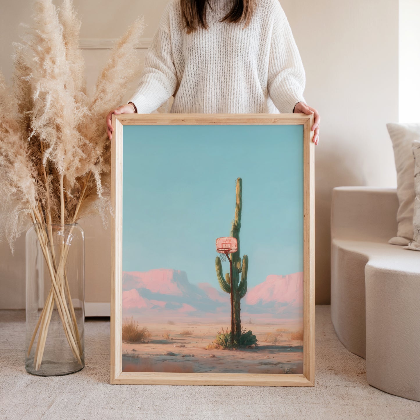 Woman holding desert cactus basketball hoop art print in modern interior, lifestyle poster wall art decor