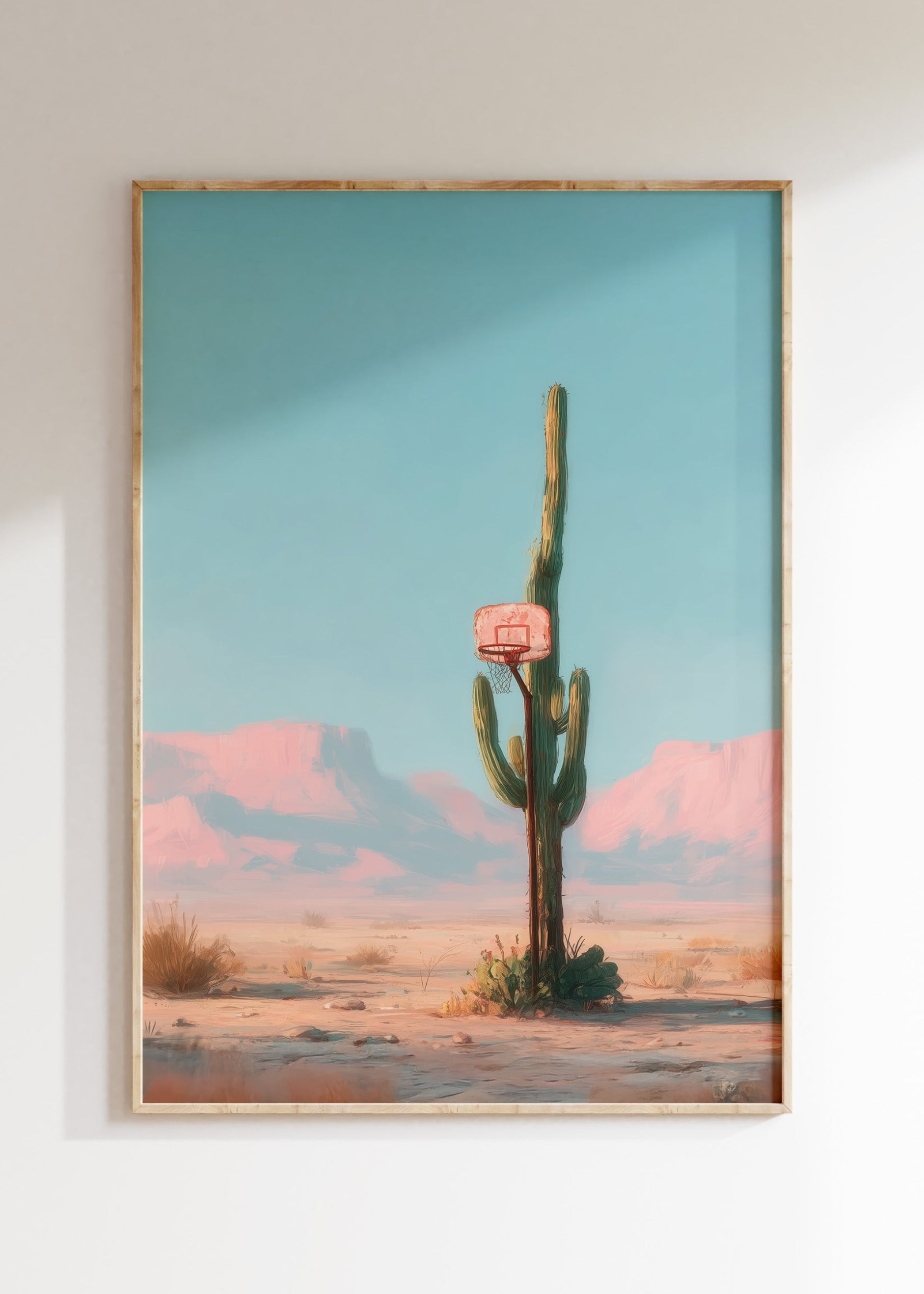 Framed desert cactus basketball hoop illustration, minimal pink and turquoise poster on white wall, home decor wall art